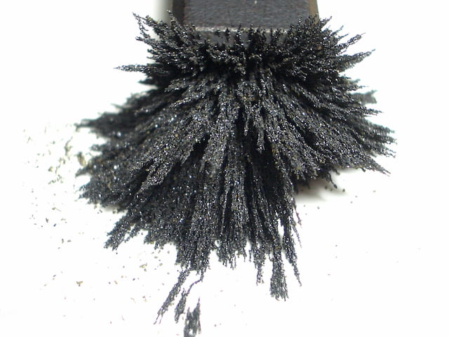 Iron powder attracted to magnet