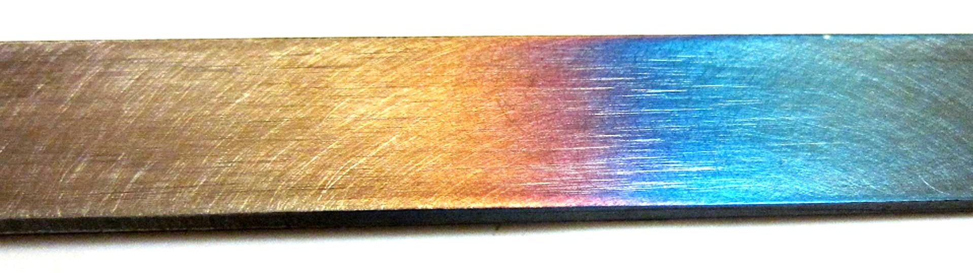 Steel tempering, various colours achieved with different tempering temperatures below the metal's lower critical point.