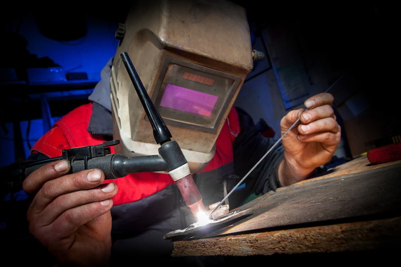 Welder performing TIG welding on aluminium parts